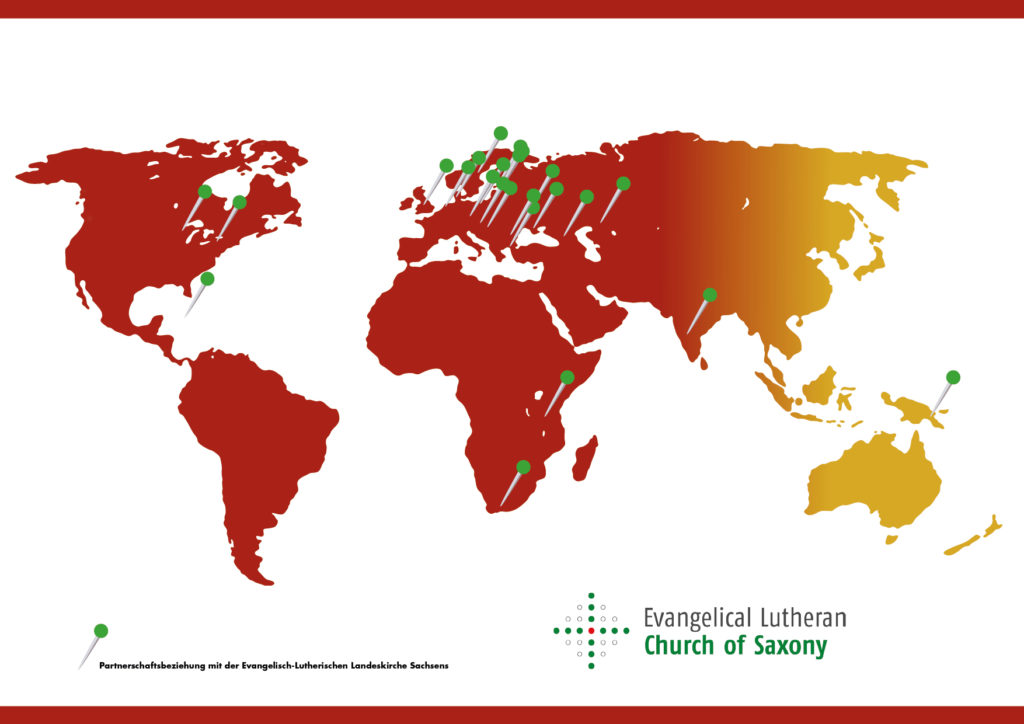 Weltkarte mit Stecknadeln, die Partnergemeinden  der evangelischen Landeskirche Sachsens weltweit anzeigen.